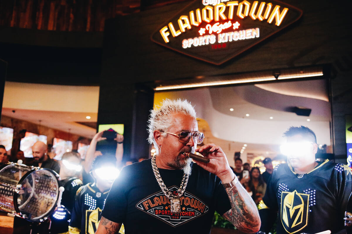 Guy Fieri smokes a cigar outside of his new restaurant on the Strip on Friday, July 7, 2023, at ...
