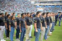 FILE - Military recruits are sworn in during halftime on Salute to Service military appreciatio ...