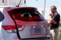 A car window is broken as North Las Vegas Police investigate where a 6-year-old girl and man in ...