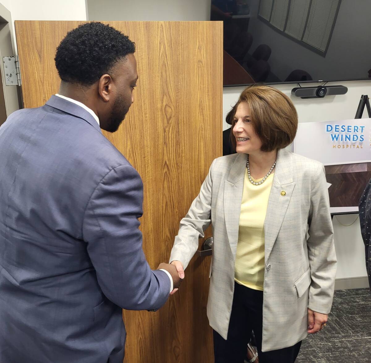 Lloyd Noble, left, shakes hands with Sen. Catherine Cortez Masto at Desert Winds Hospital on Ju ...