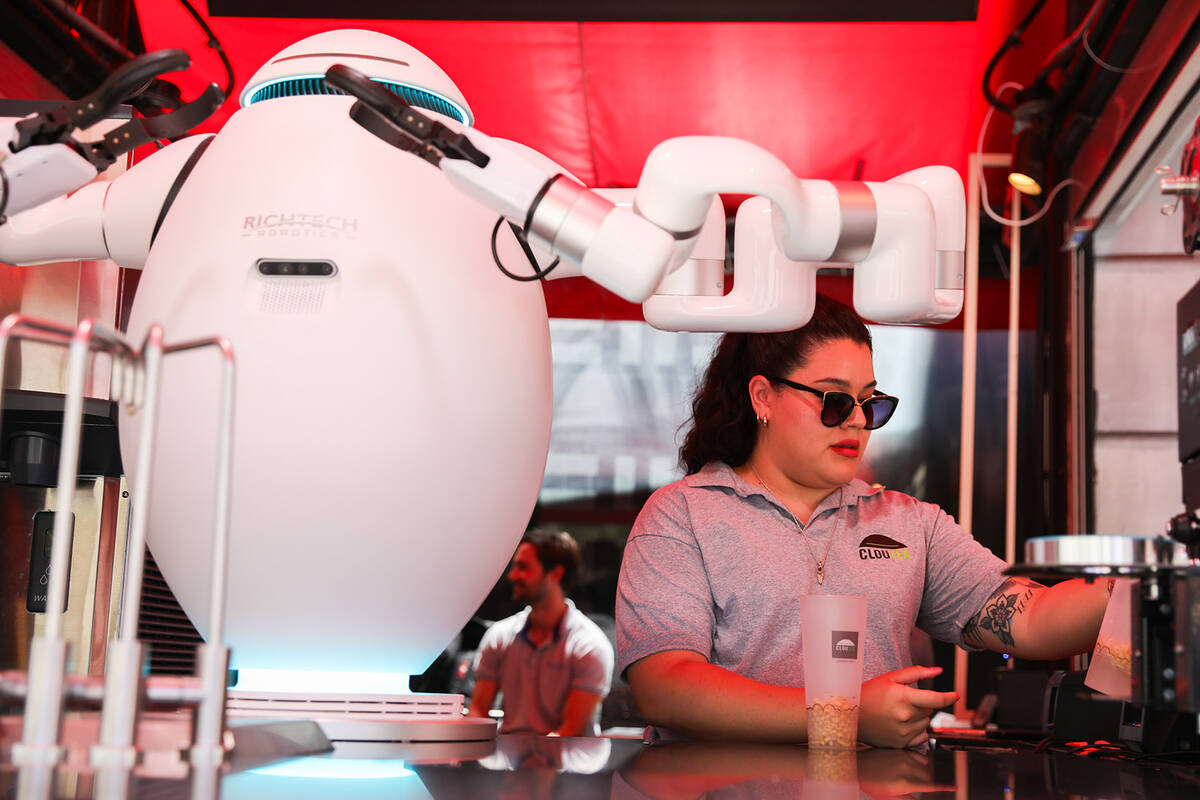 After Paola Valdez takes a customer’s order, Adam the robot prepares the customer’ ...