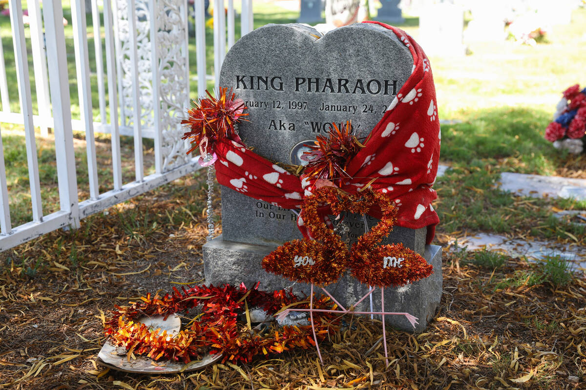 A pet’s tombstone is decorated with streamers and towels at the Craig Road Pet Cemetery, ...