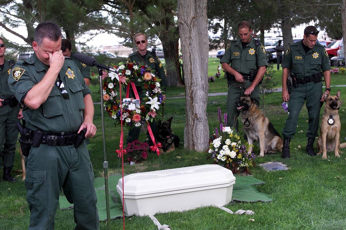 Las Vegas police K-9 officer Frank Sorrentino tears up over the casket of his partner Danny, du ...