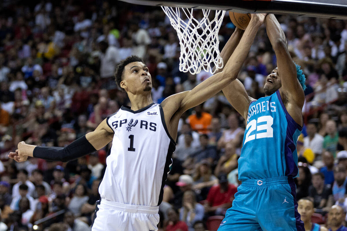 San Antonio Spurs forward Victor Wembanyama (1) attempts to block Charlotte Hornets forward/cen ...