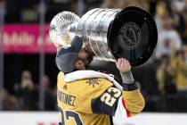 Golden Knights defenseman Alec Martinez (23) kisses the Stanley Cup after his team won the NHL ...