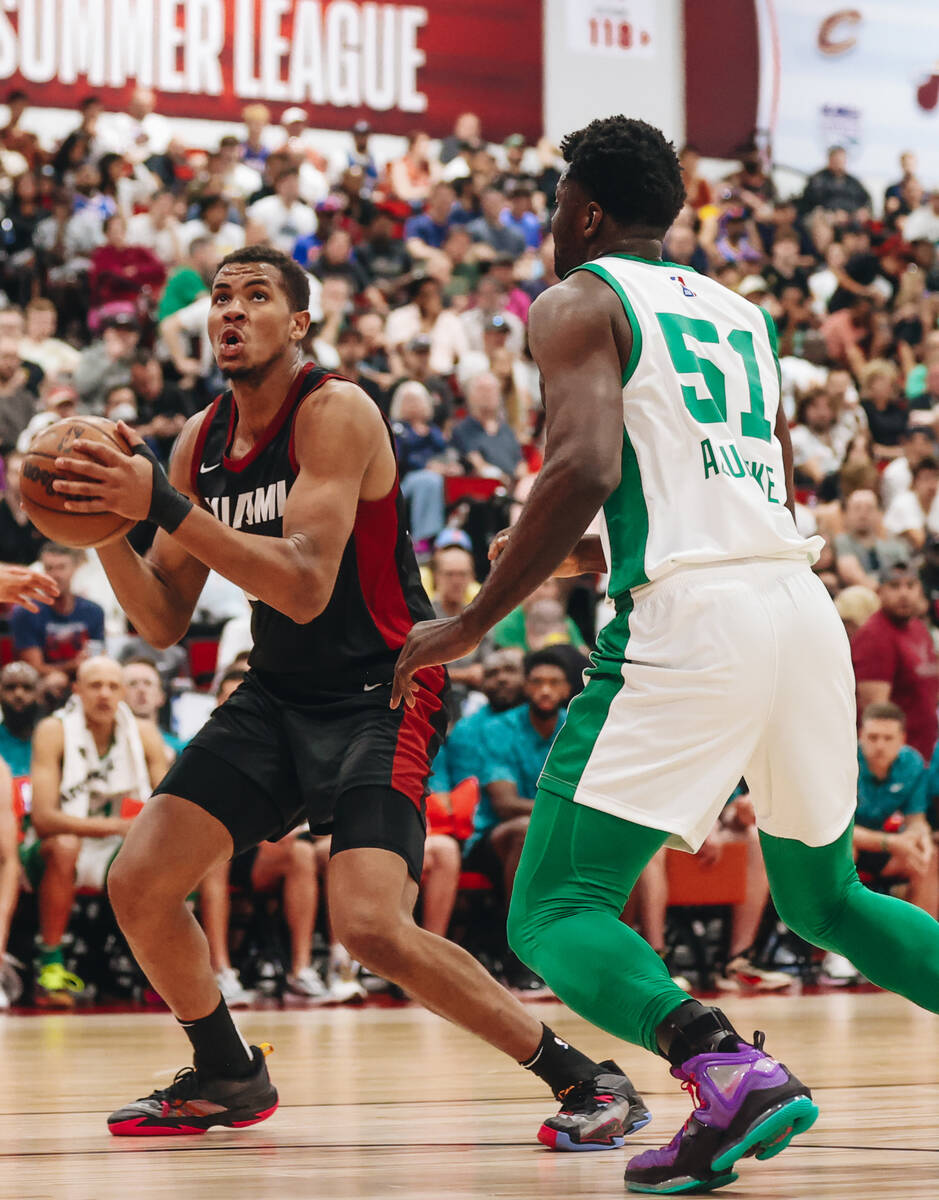 Miami Heat center Orlando Robinson looks to shoot the ball into the hoop as Boston Celtics cent ...