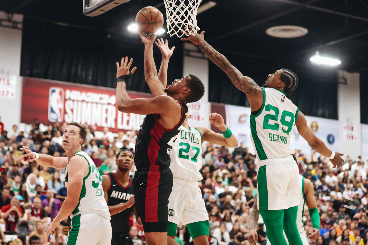Miami Heat center Orlando Robinson (25) makes a basket as Boston Celtics guard Jay Scrubb (29) ...