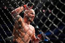 FILE - Alexander Volkanovski reacts after winning a featherweight title bout against Max Hollow ...