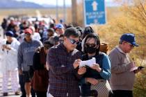 FILE - People who declined to give their names make their picks as they wait in line to buy lot ...