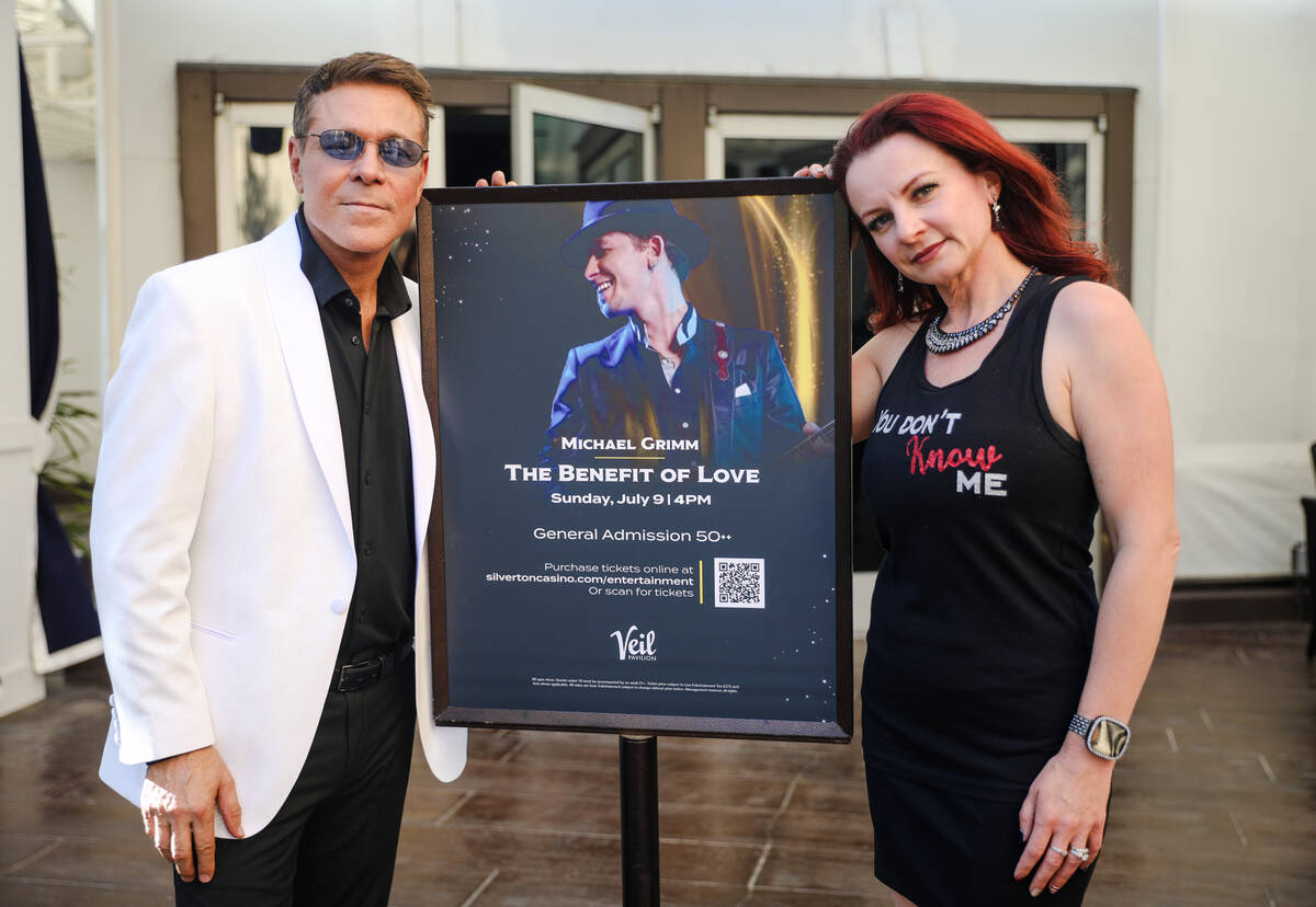 Vegas showman Mark OToole, left, and Lucie Grimm, wife of Michael Grimm, right, pose for a port ...