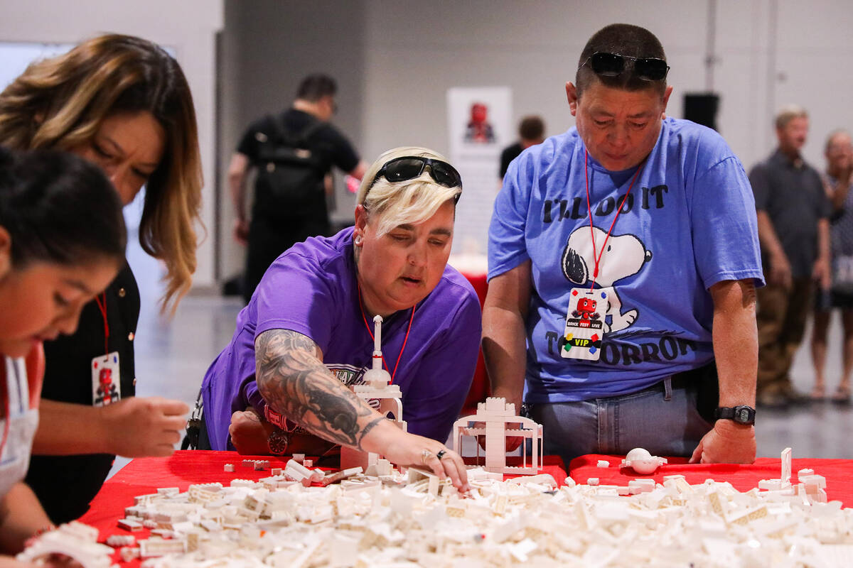Laurie Clark, left, and Nicki Clark create a building out of LEGO bricks at the Brick Fest Live ...