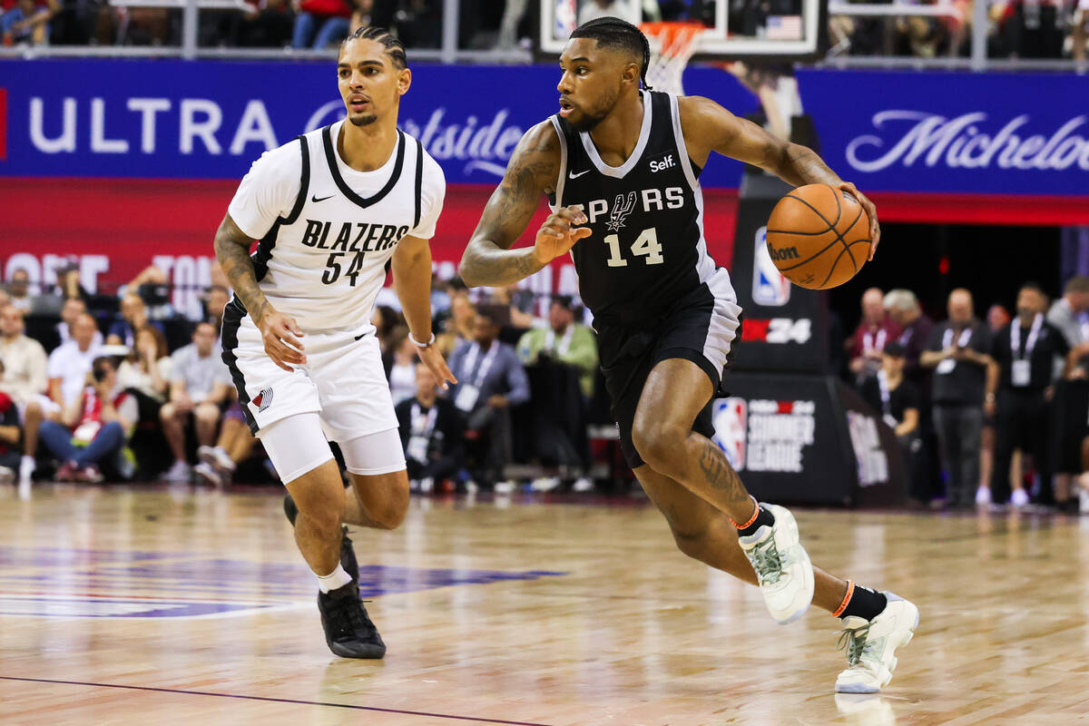 San Antonio Spurs guard Blake Wesley (14) drives to the basket past Portland Trailblazers guard ...