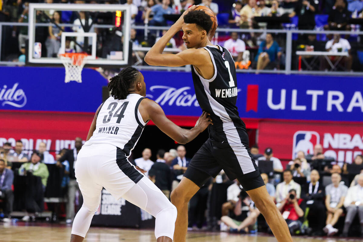 San Antonio Spurs forward Victor Wembanyama (1) moves the ball past Portland Trailblazers forwa ...