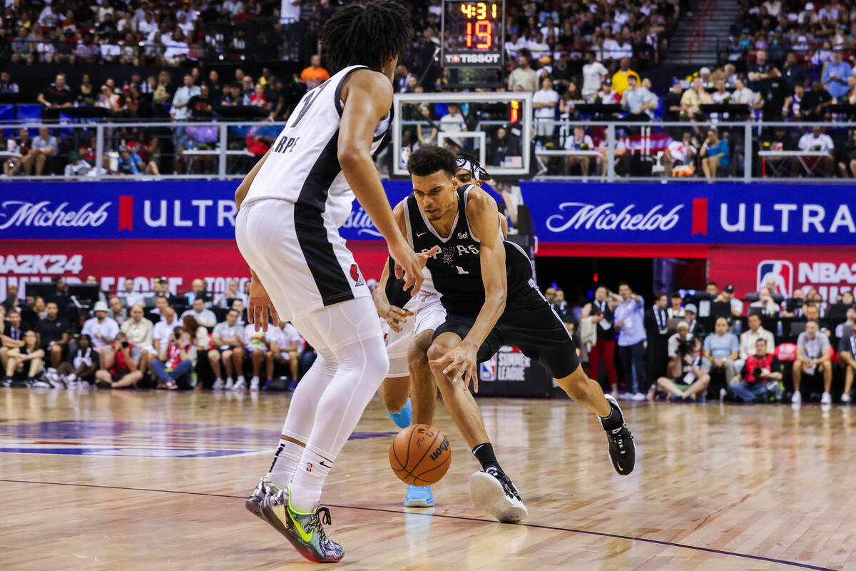 San Antonio Spurs forward Victor Wembanyama (1) drives the ball down the court during an NBA Su ...