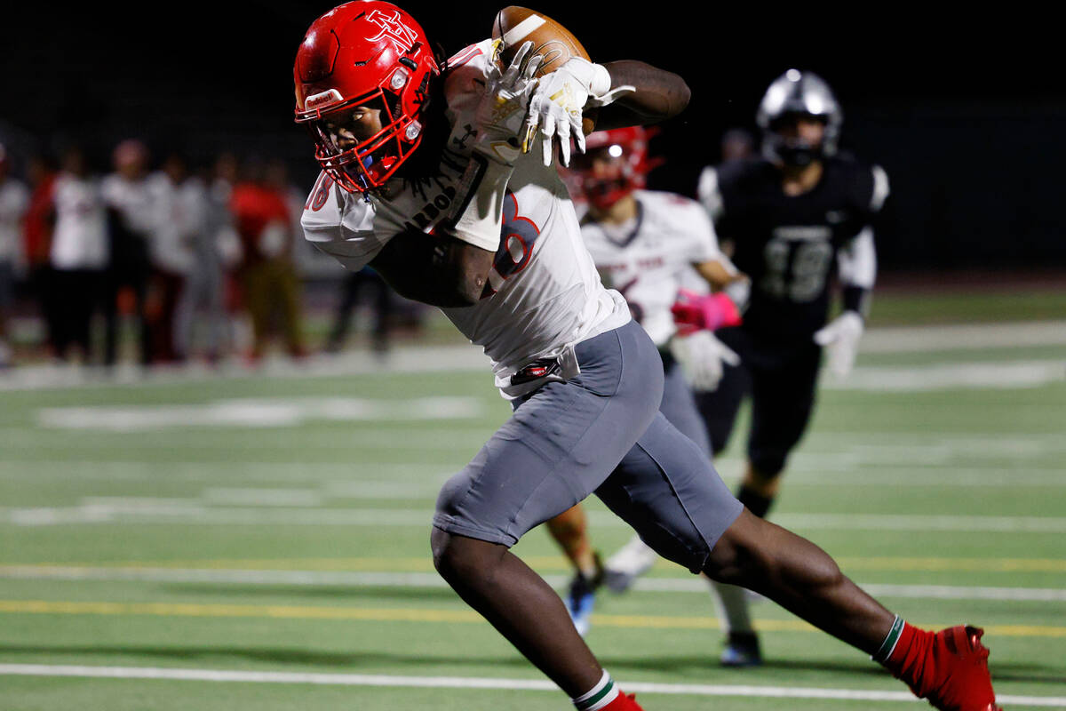 Arbor View’s David Washington (18) catches the pass and runs into the end zone for a tou ...