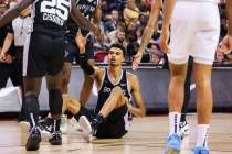 San Antonio Spurs forward Victor Wembanyama (1) is helped up from his teammates after being fou ...