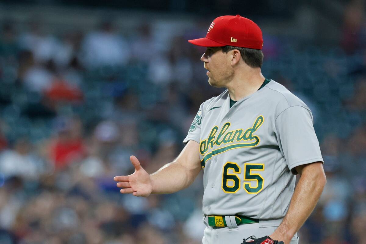 Oakland Athletics pitcher Trevor May (65) gestures to the home plate umpire when the pitch to D ...