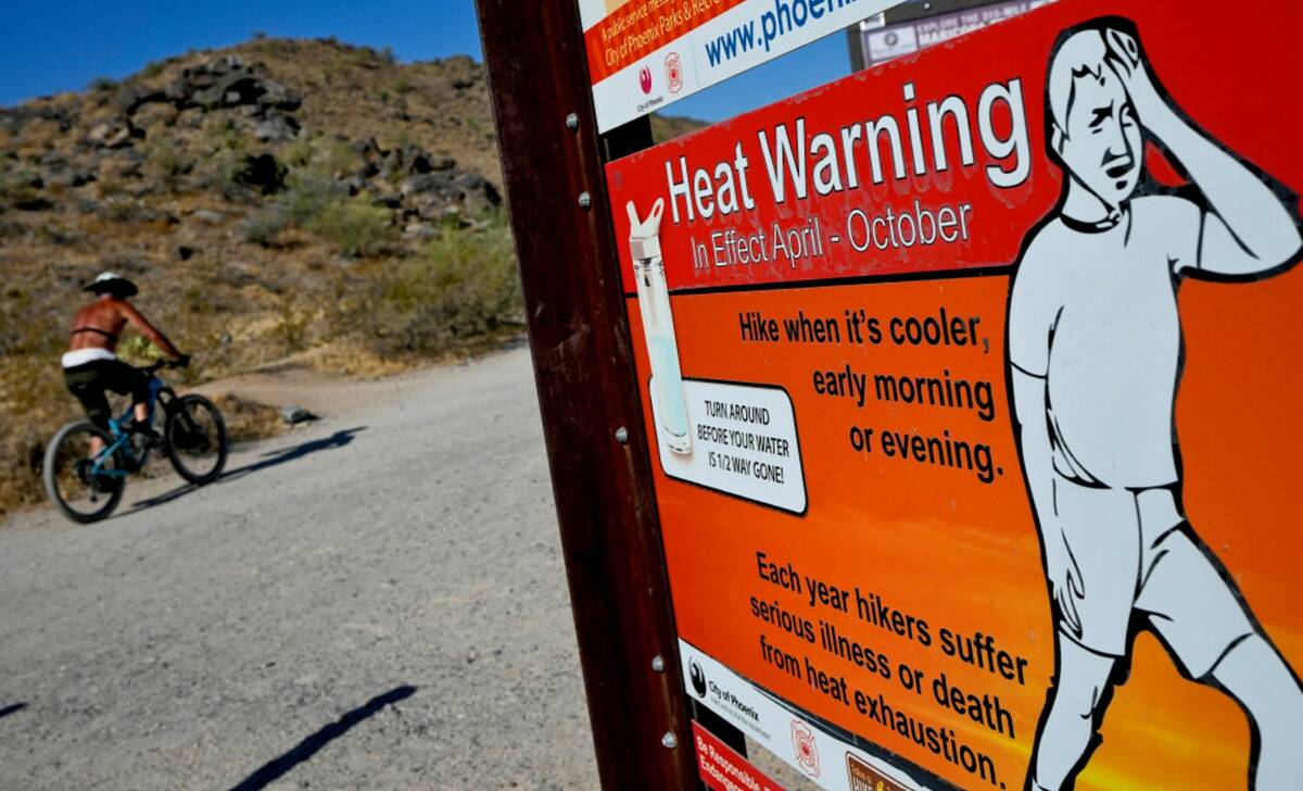 A cyclist finishes his ride early to beat high temperatures, Monday, July 10, 2023, in Phoenix. ...