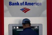 File - A customer uses an ATM at a Bank of America location in San Francisco, Monday, April 24, ...