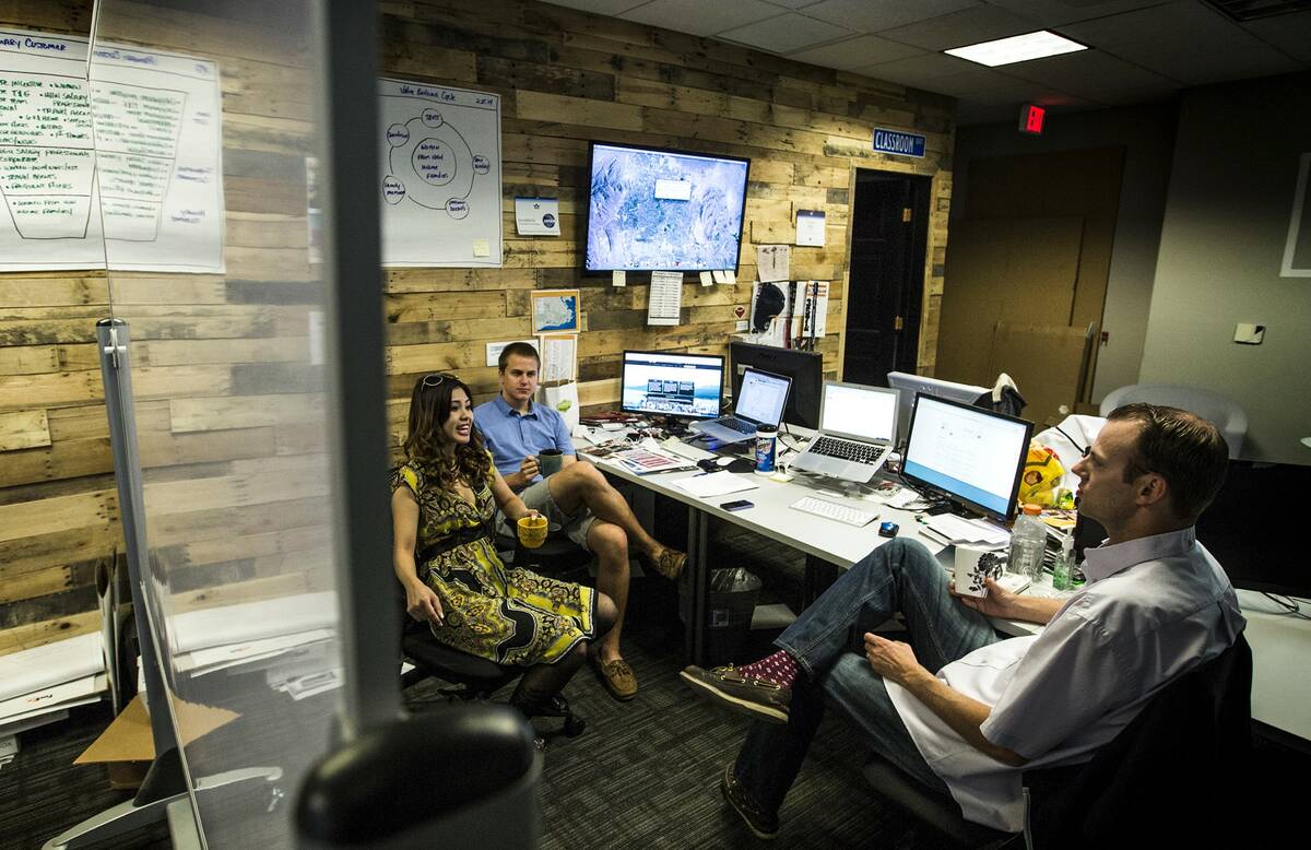 Tom Ellingson, right, co-founder CEO of Fandeavor, and Jacob Sudek talk to Kimberly Do at a cow ...