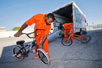 Inmates Omar Kemp, left, and Ryan Brandon check the bikes which were delivered by National Bike ...