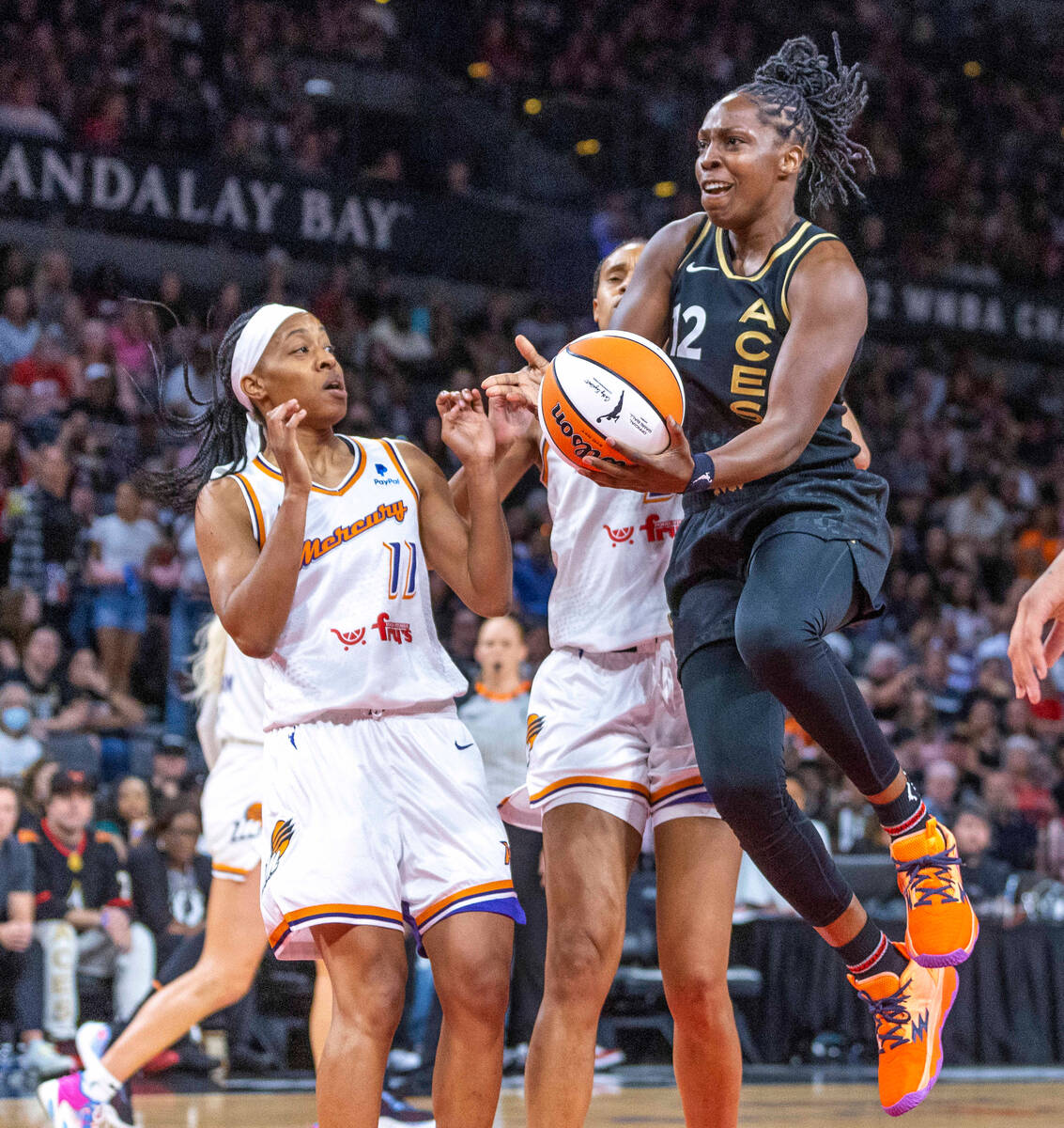 Aces guard Chelsea Gray (12) elevates to score past Phoenix Mercury forward Brianna Turner (21) ...