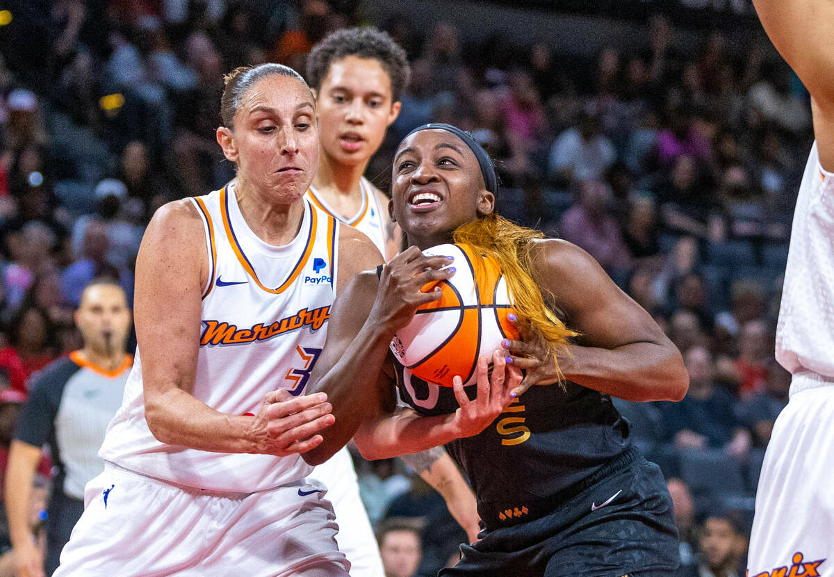 Aces guard Jackie Young (0) fights for the ball and a shot attempt with Phoenix Mercury guard D ...