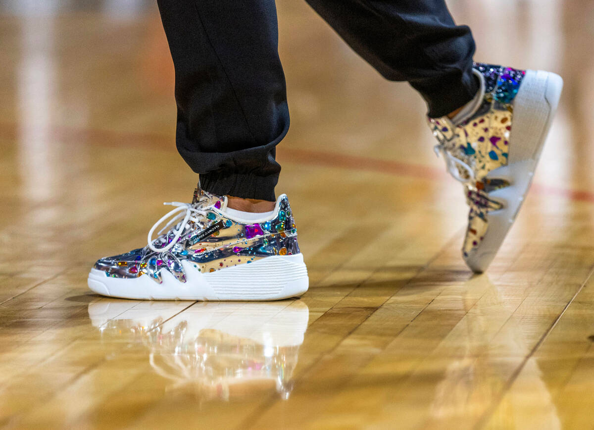 Aces head coach Beck Hammon sports bling sneakers against the Phoenix Mercury during the first ...