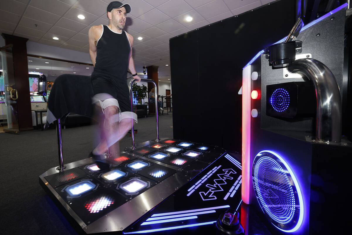 Justin Kuret of Las Vegas, shows off footwork as he plays StepManiaX, a rhythm game, at Red Not ...