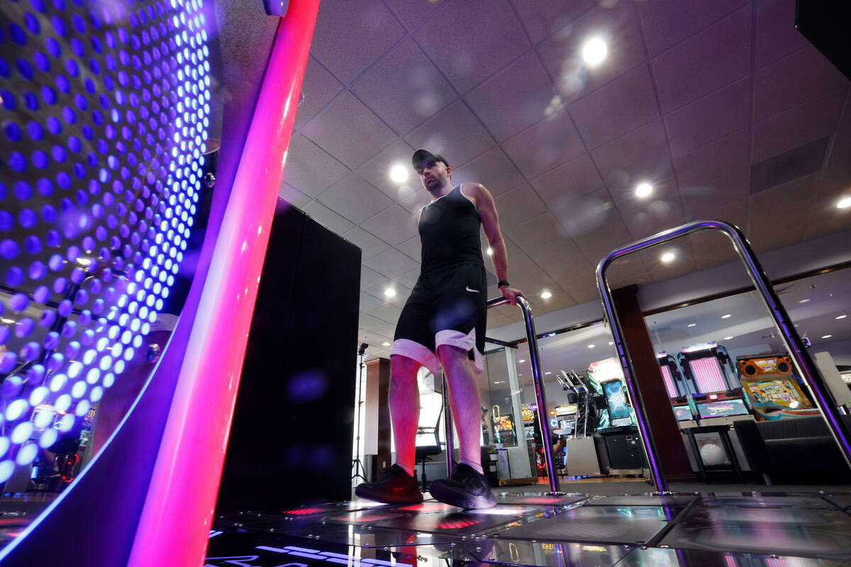 Justin Kuret of Las Vegas, shows off footwork as he plays StepManiaX, a rhythm game, at Red Not ...