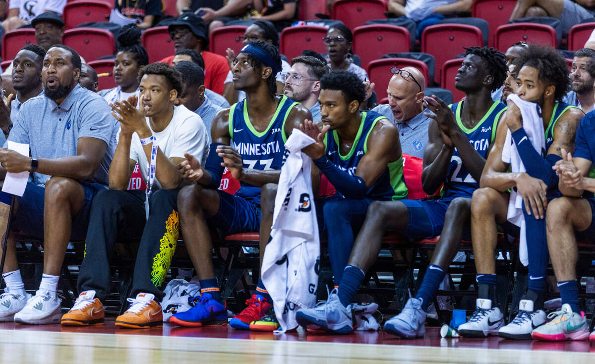 Minnesota Timberwolves forward Leonard Miller (33) cheers with teammates on the bench against A ...