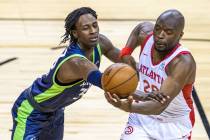 Minnesota Timberwolves forward Leonard Miller (33) grabs the arm of Atlanta Hawks forward Mfion ...