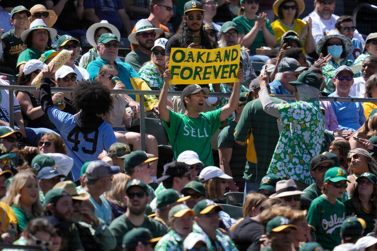 An Oakland Athletics fan holds up a sign protesting the team's planned move to Las Vegas during ...