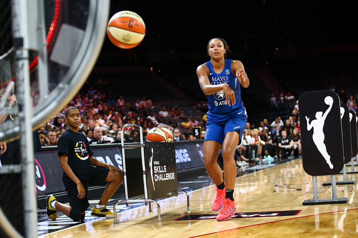 Minnesota Lynx's Napheesa Collier competes in an obstacle course involving passing and shooting ...