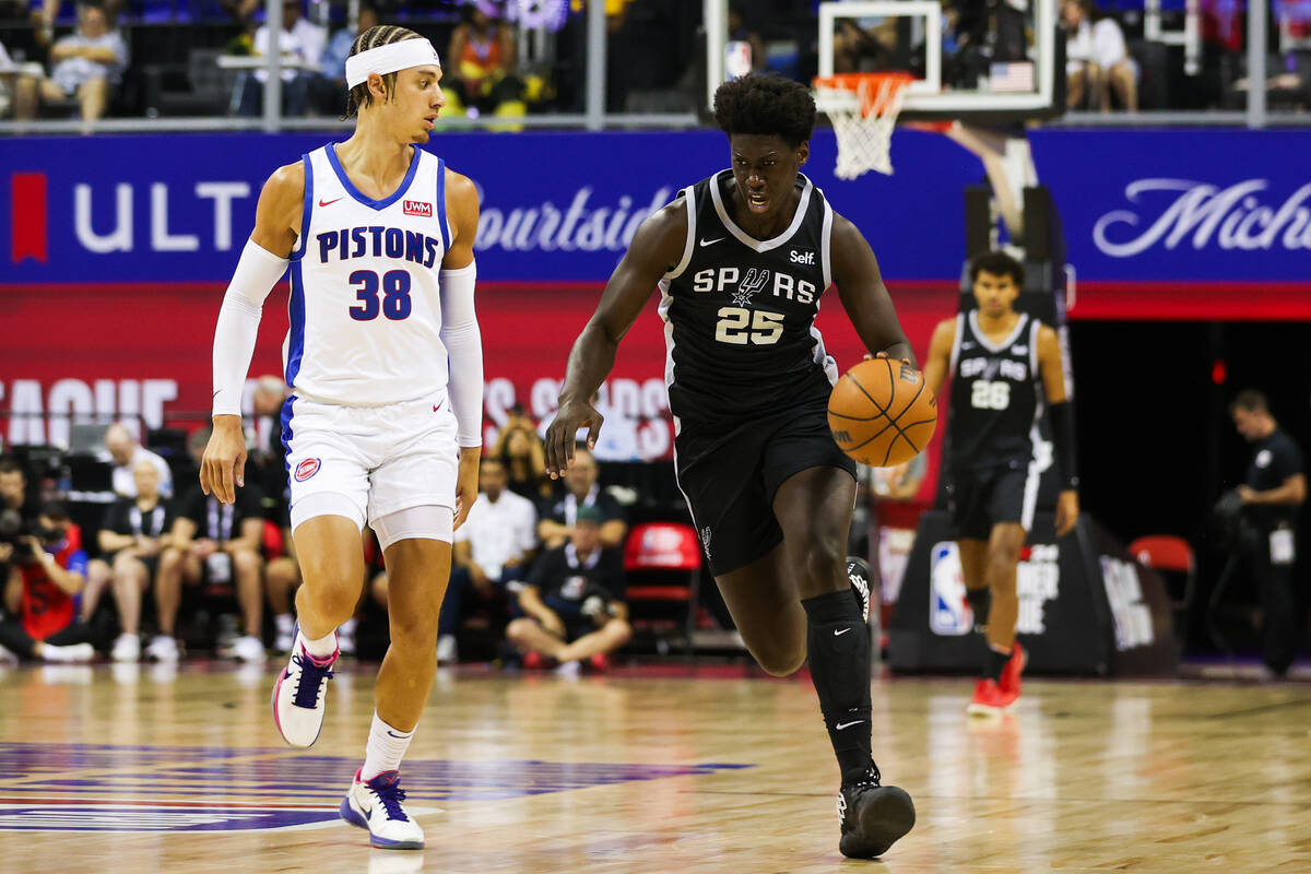 San Antonio Spurs guard/forward Sidy Cissoko (25) drives down the court past Detroit Pistons fo ...