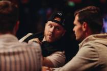Steven Jones, center, speaks to Daniel Holzner during the World Series of Poker $10,000 buy-in ...