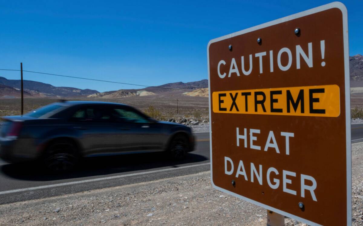 A sign stands warning of extreme heat Tuesday, July 11, 2023, in Death Valley National Park, Ca ...