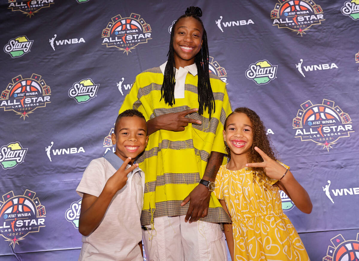 Jewell Loyd of Seattle Storm poses for a photo with her nephew Josiah, 9, and niece Sarai, 7, o ...