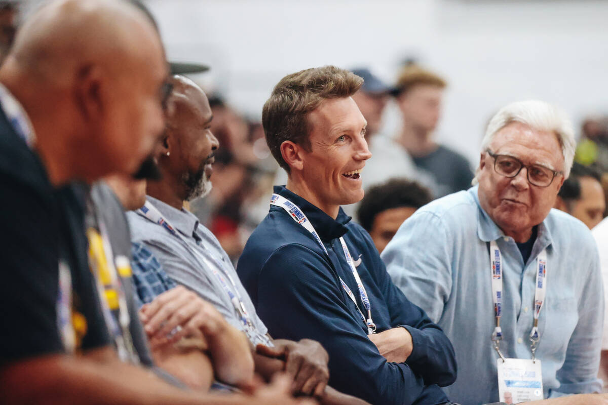 Golden State Warriors general manager Mike Dunleavy speaks to other people on the sidelines dur ...