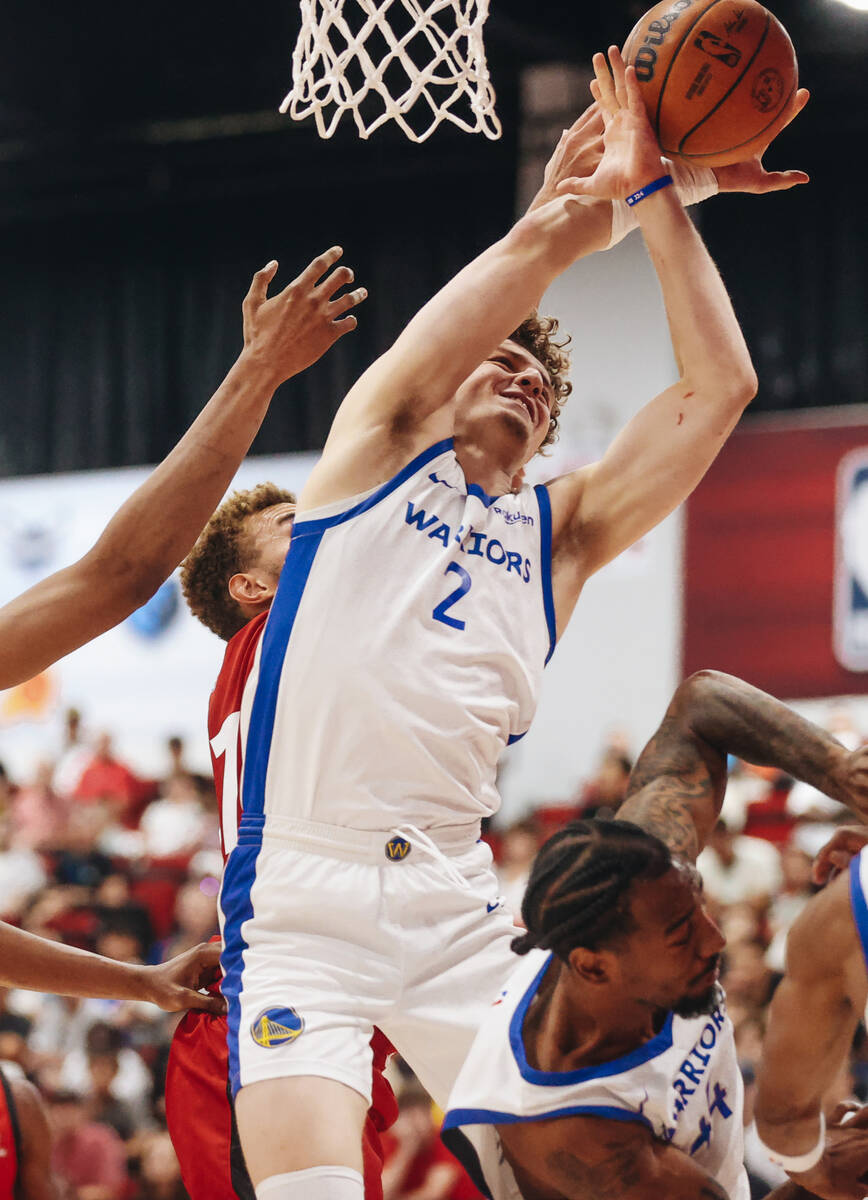 Golden State Warriors guard Brandin Podziemski (2) fights to grab the ball for a steal during a ...