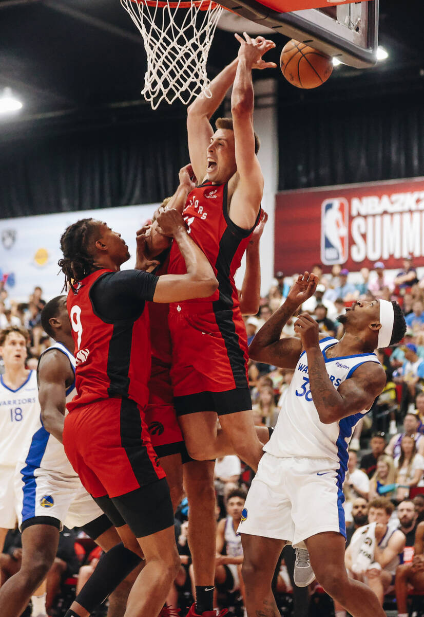 Toronto Raptors guard/forward Joe Wieskamp (center) misses the ball during an attempt to steal ...