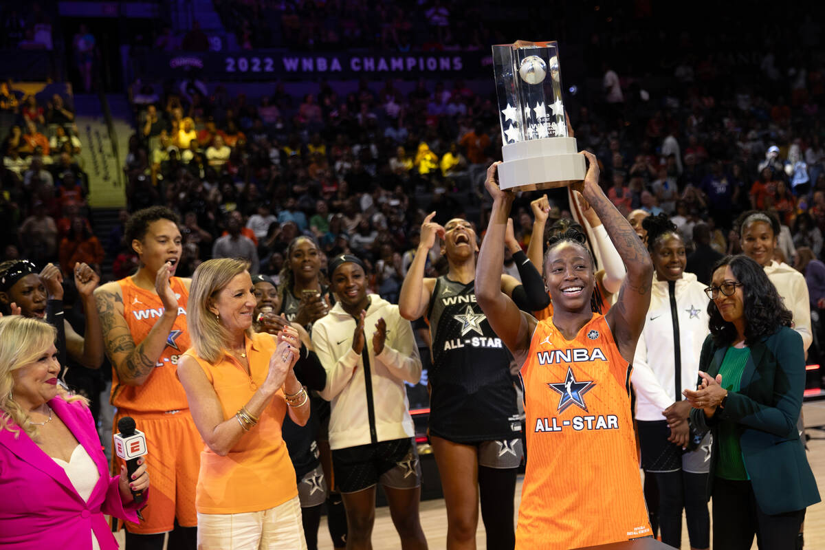 The Seattle Storm’s Jewell Loyd, of Team Stewart, holds up her MVP trophy after the WNBA ...