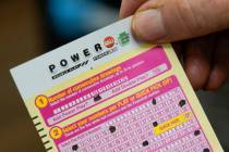 FILE - Steve Morton shows his scan card for his personal selection numbers for a ticket for a M ...