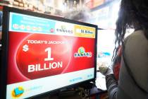 FILE - People line up to purchase lottery tickets for the drawing of the Powerball lottery at t ...