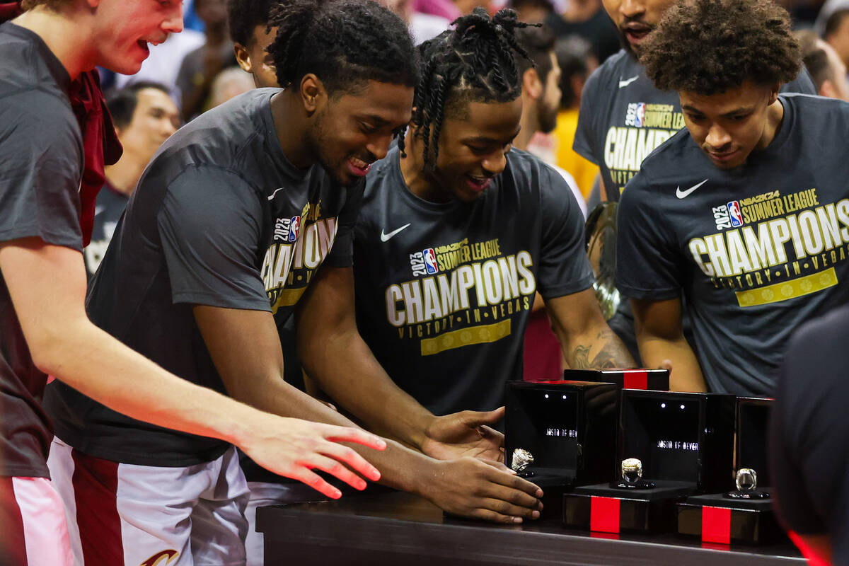 Cleveland Cavaliers players reach for their rings after winning the NBA Summer League champions ...