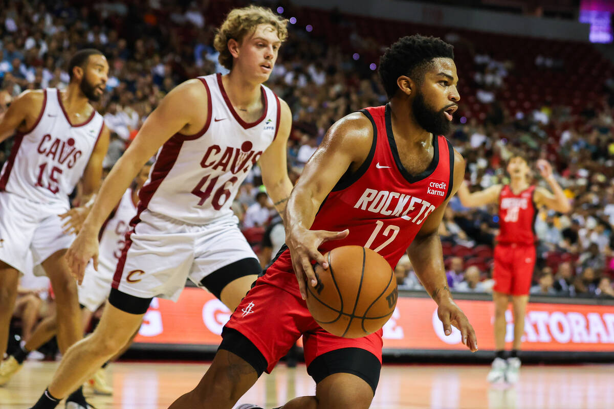 Houston Rockets guard Trevor Hudgins (12) drives the ball down the court followed by Cleveland ...