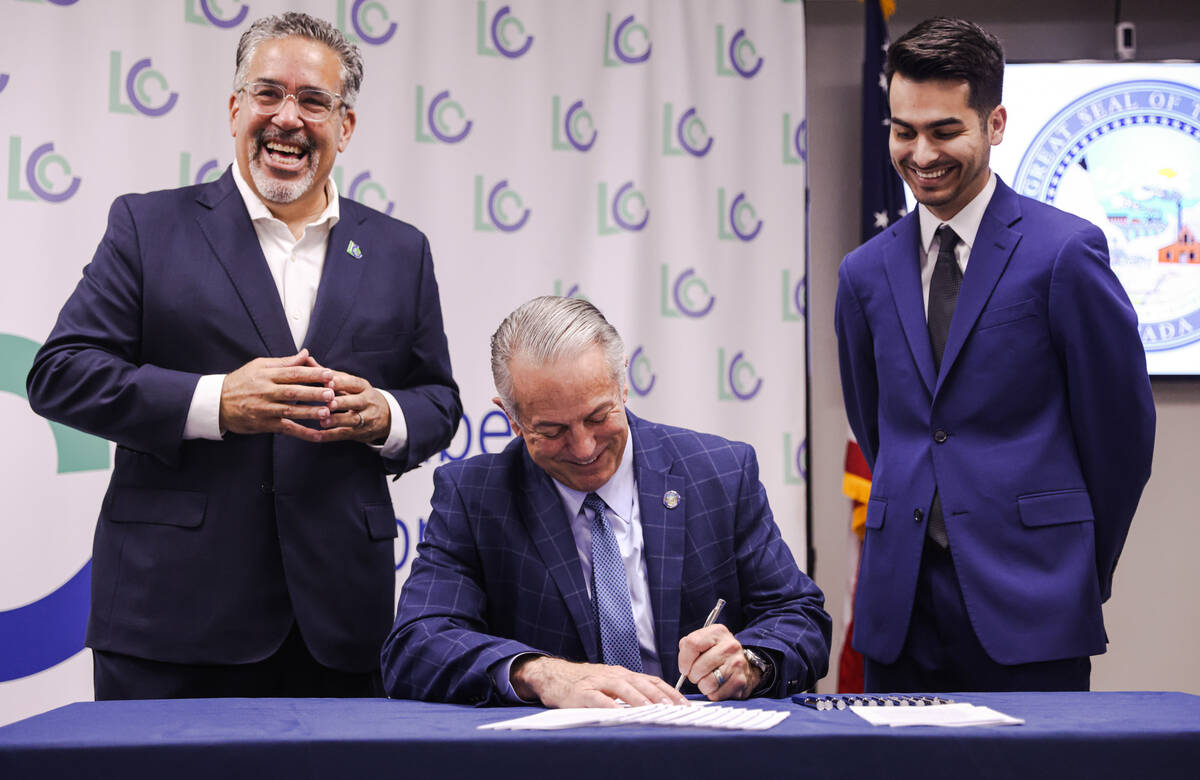 Peter Guzman, president of the Latin Chamber of Commerce, from left, smiles as Gov. Joe Lombard ...