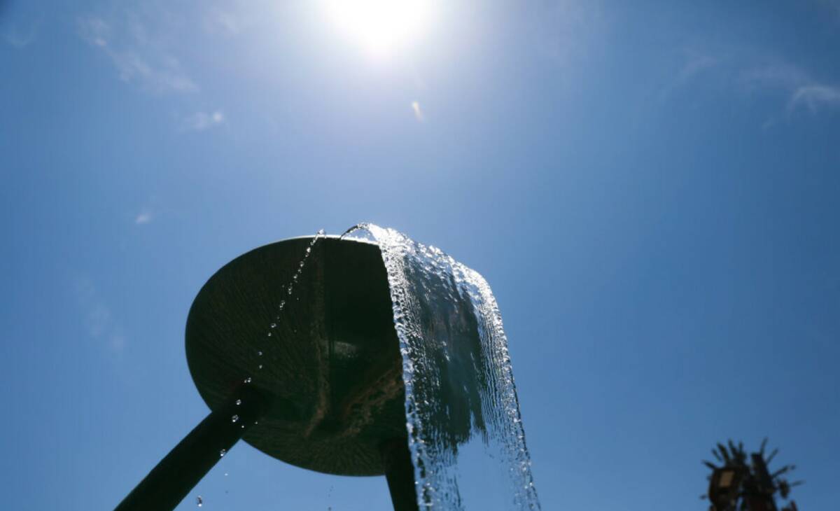 A miniature water park at Bob Baskin Park helps local residents cool down during the 110 degree ...