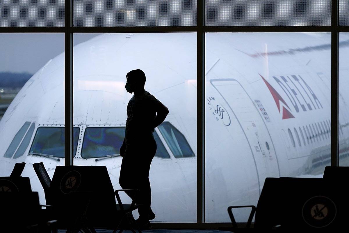 A passenger waits for a Delta Airlines flight at Hartsfield-Jackson International Airport in At ...