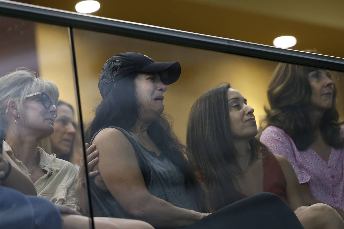 Brandon Farber’s mother Dawn, second from left, watches a slide show to honor the memory of h ...